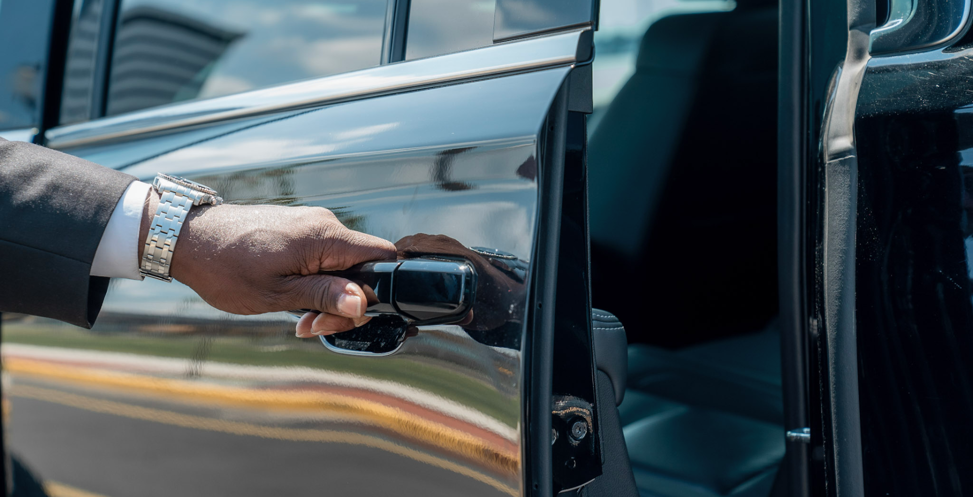 Chauffeur opening a limo door
