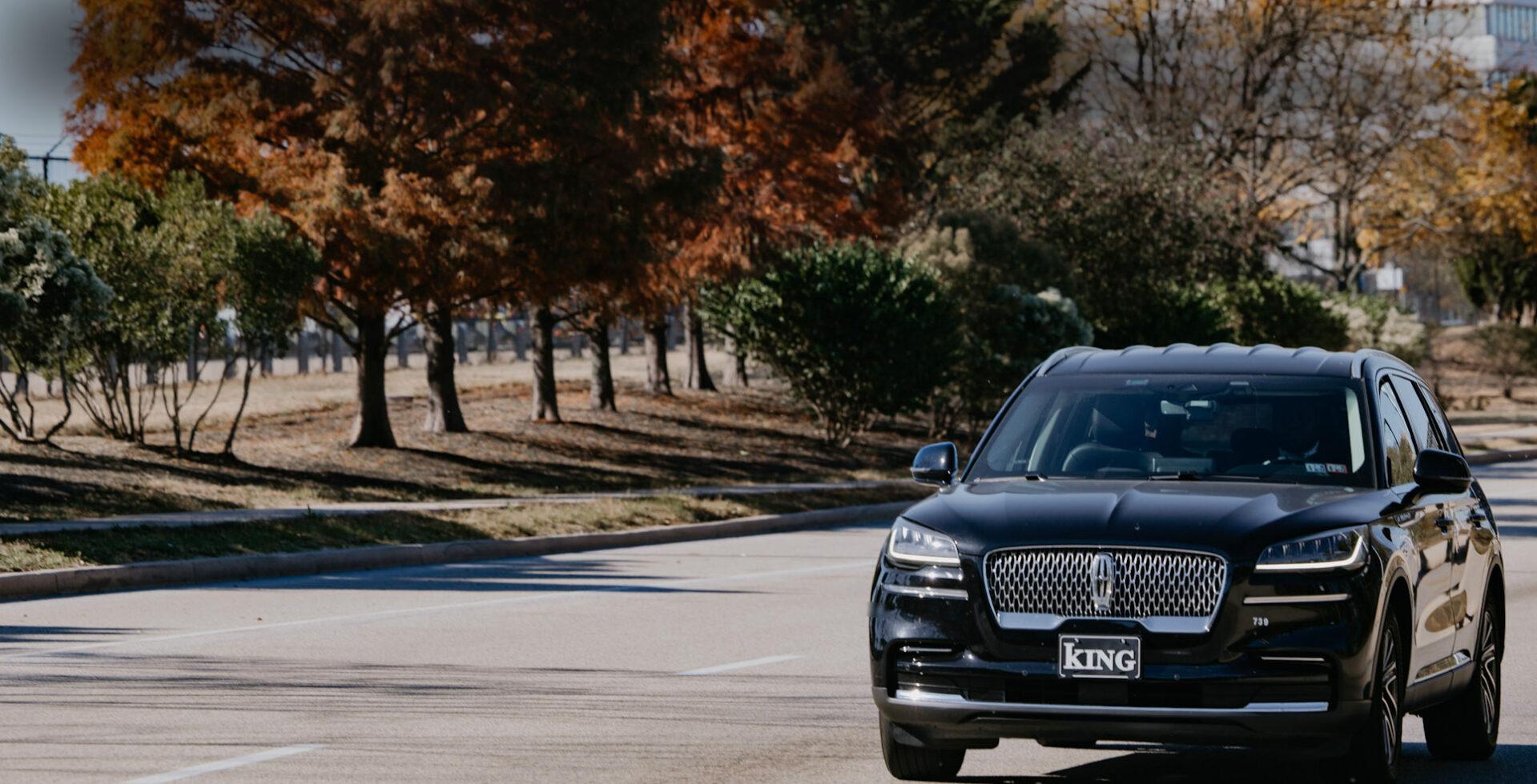 Sedan driving on a road in the fall