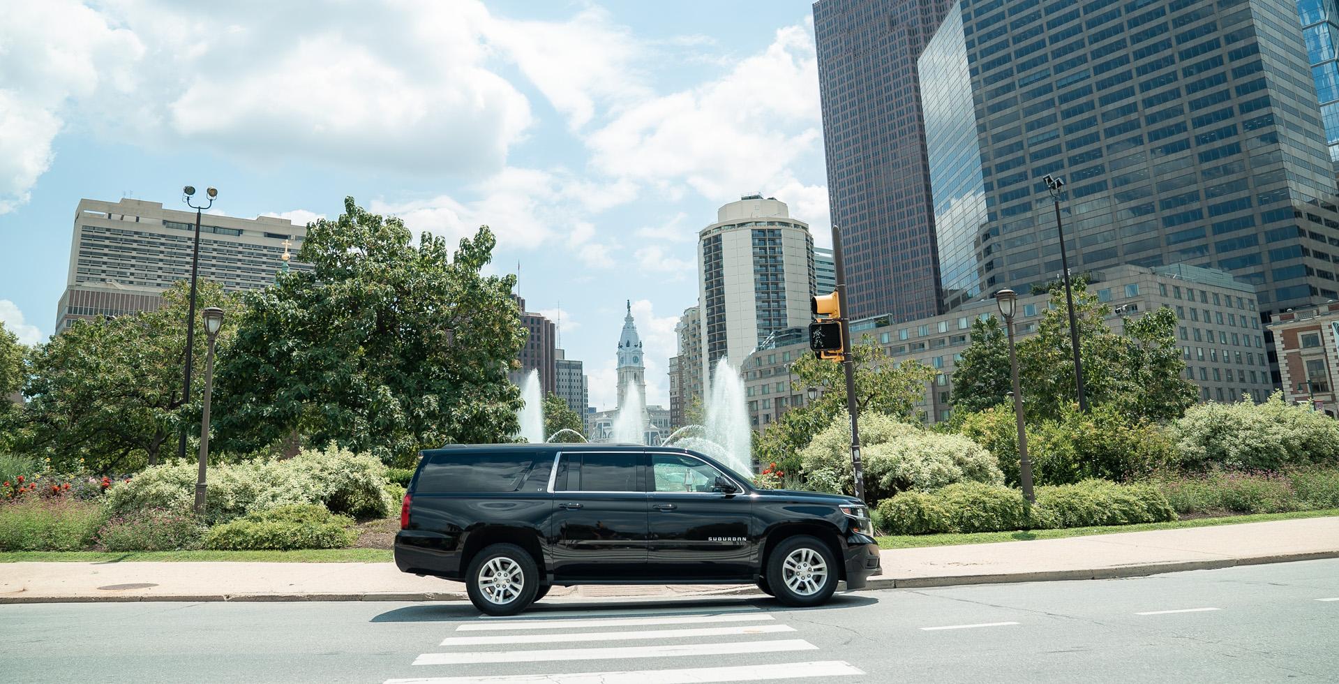 Black SUV in front of a fountain