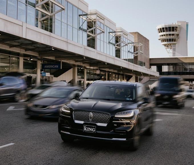 cars driving by the airport