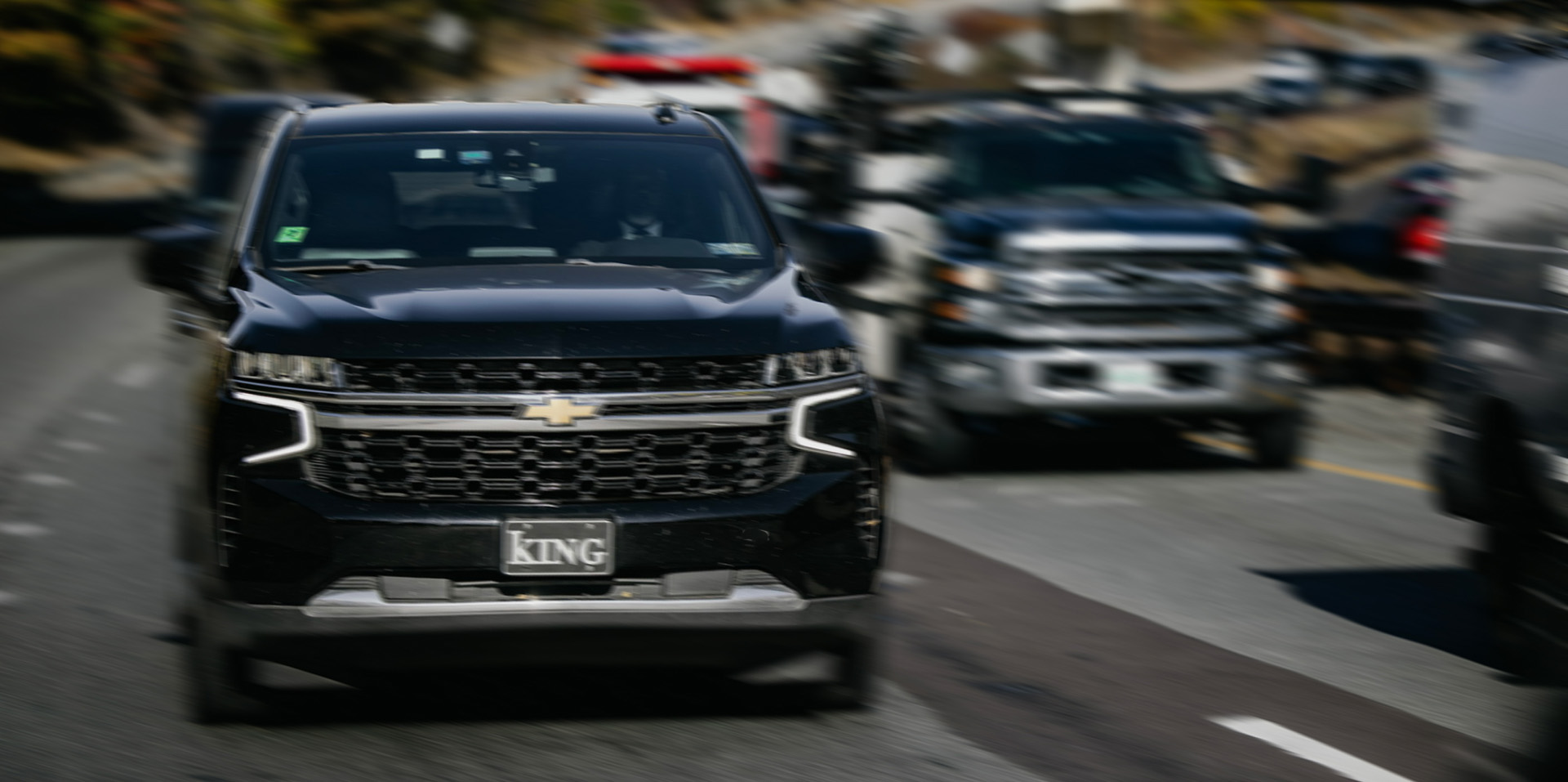 Black SUVs on a highway